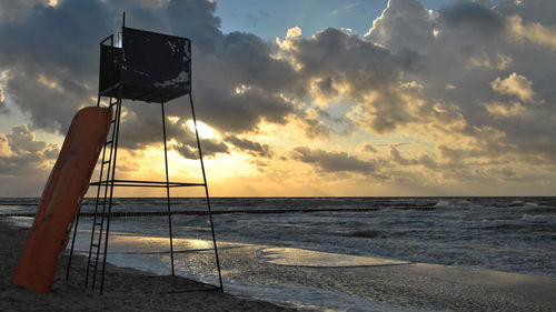 Scenic view of beach against sky during sunset