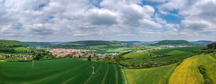 Panoramic view of agricultural field against sky