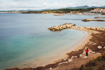 High angle view of teenage girl standing at beach