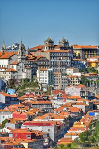 Buildings in city against clear sky