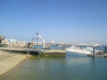 View of commercial dock against clear blue sky
