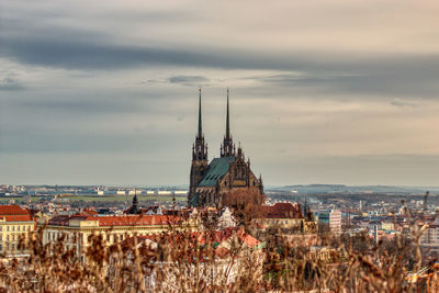 Brno church from far with grey clouds