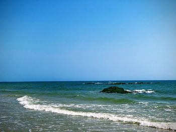 Scenic view of sea against clear blue sky