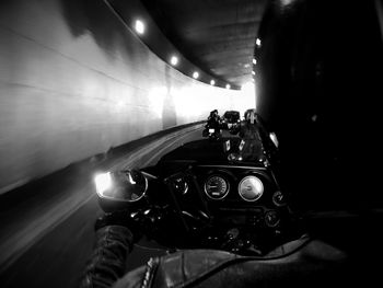 Man photographing illuminated tunnel