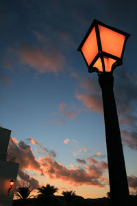 Low angle view of silhouette street light against sky during sunset