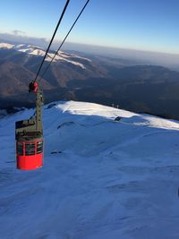 Scenic view of snow covered mountains against sky