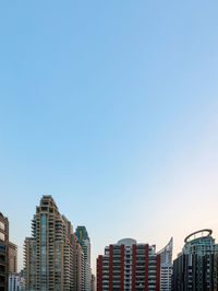 Modern buildings against clear blue sky