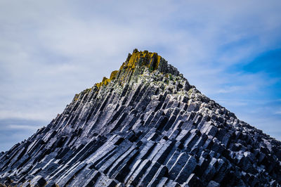 Low angle view of rock against sky