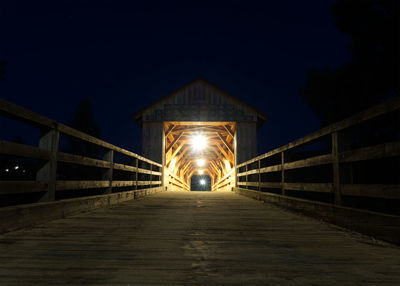 Illuminated footbridge at night