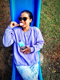 Portrait of smiling young woman standing on field