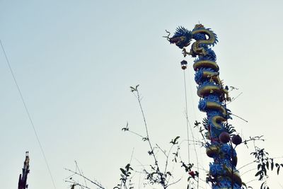 Low angle view of christmas tree against clear sky