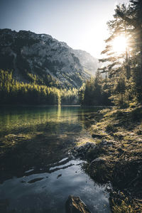 Scenic view of lake by mountains against sky