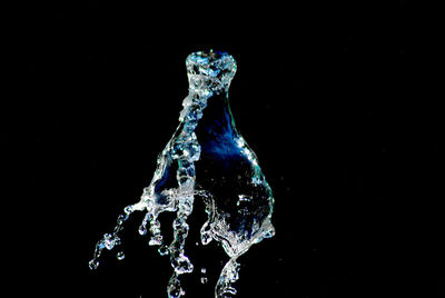 Close-up of water splashing against black background