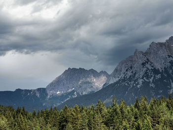 Scenic view of mountains against cloudy sky in mittenwald, bavarian alps 