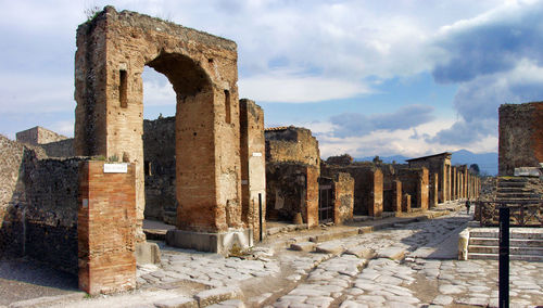 Old ruins of building against cloudy sky