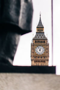 Clock tower against sky in city