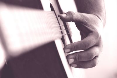 Close-up of man playing guitar