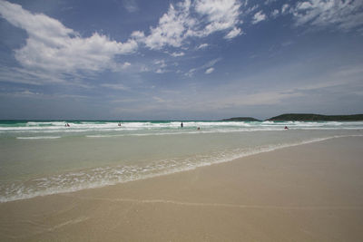 View of beach against cloudy sky