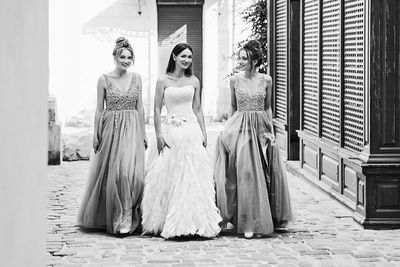 Rear view of woman standing against wall