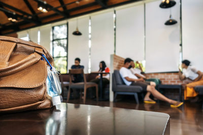 Close-up of purse on table in restaurant