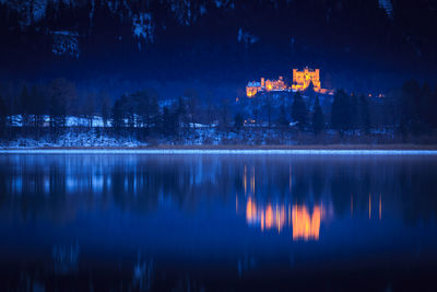 Reflection of buildings in lake at night