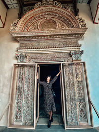 Full length of woman standing against ceiling