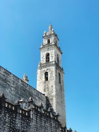 Low angle view of historic building against clear blue sky