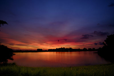 Scenic view of lake against sky at sunset