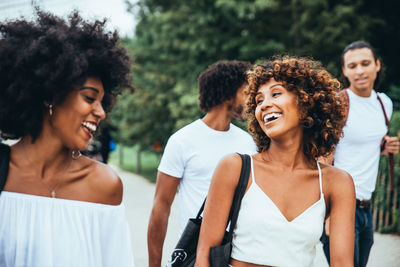 Smiling friends walking 