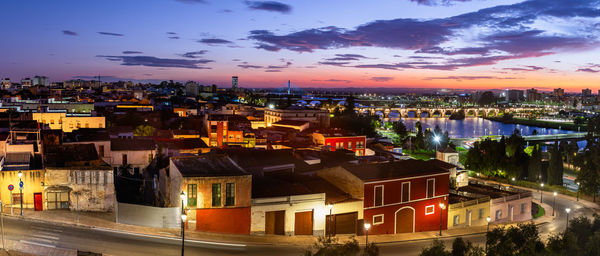 High angle view of illuminated buildings in city at night