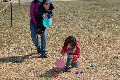 Mom with two kids are doing a race and easter egg hunt at the fair