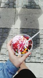 High angle view of woman holding ice cream