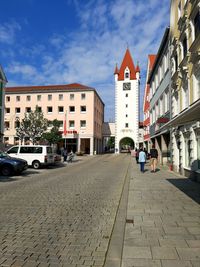 Street amidst buildings in city against sky