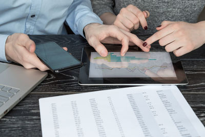 High angle view of man using mobile phone on table