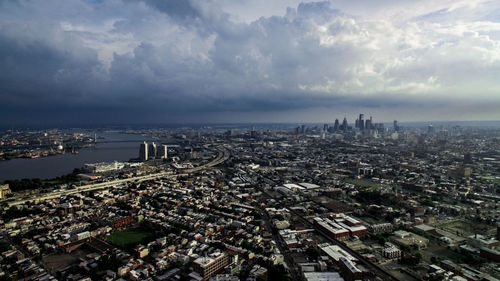 Aerial view of cityscape against cloudy sky in stormy weather