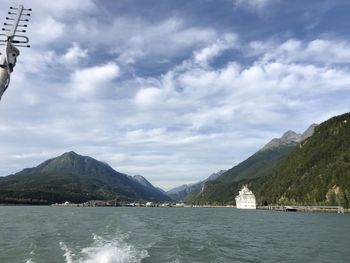 Scenic view of sea and mountains against sky