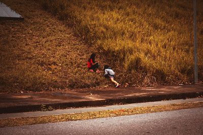 Woman running on road in city