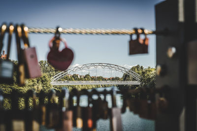 Padlocks on bridge over river