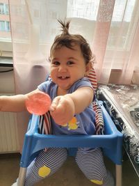 Portrait of cute baby girl smiling at home