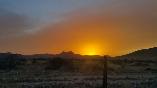 Scenic view of landscape against sky during sunset