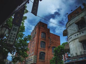 Low angle view of building against cloudy sky