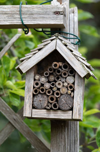 Close-up of birdhouse on wooden fence