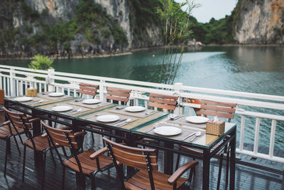 Place setting at restaurant against lake