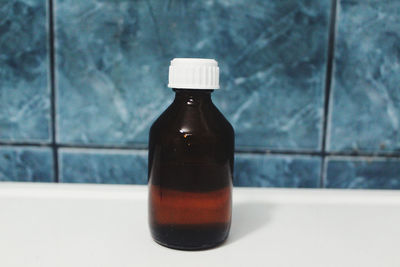 Close-up of glass bottle on table