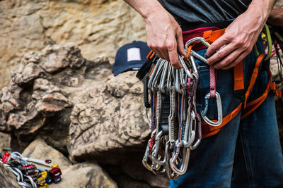 Midsection of hikers with carabiners