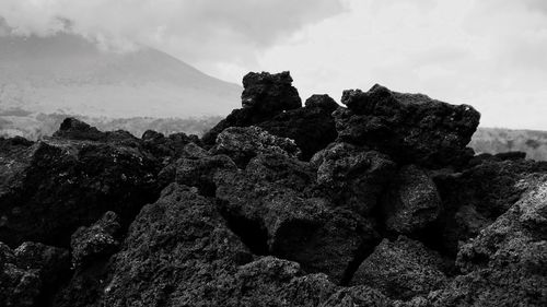 Close-up of rock formation in sea against sky