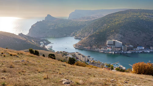 High angle view of sea and mountains against sky