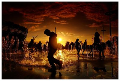 People on beach at sunset