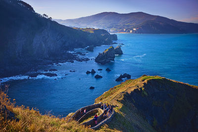 Bermeo, spain , december 28, 2019 tourists climbing to the hermitage of san juan de gaztelugatxe