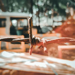Close-up of rusty metal on rope